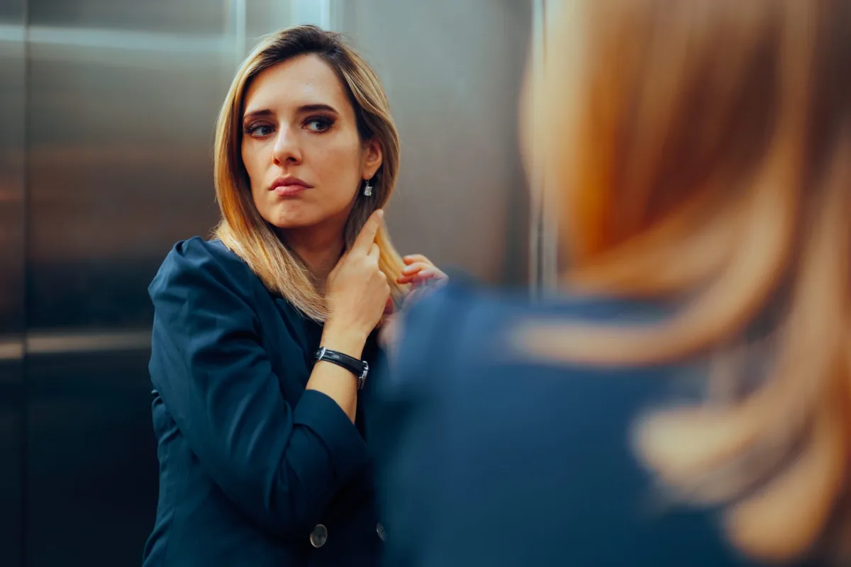 A woman listens carefully to another person during a conversation.
